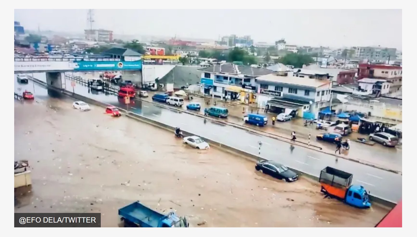 Floodwaters submerge a major Accra road during heavy rains, stranding vehicles on the carriageway